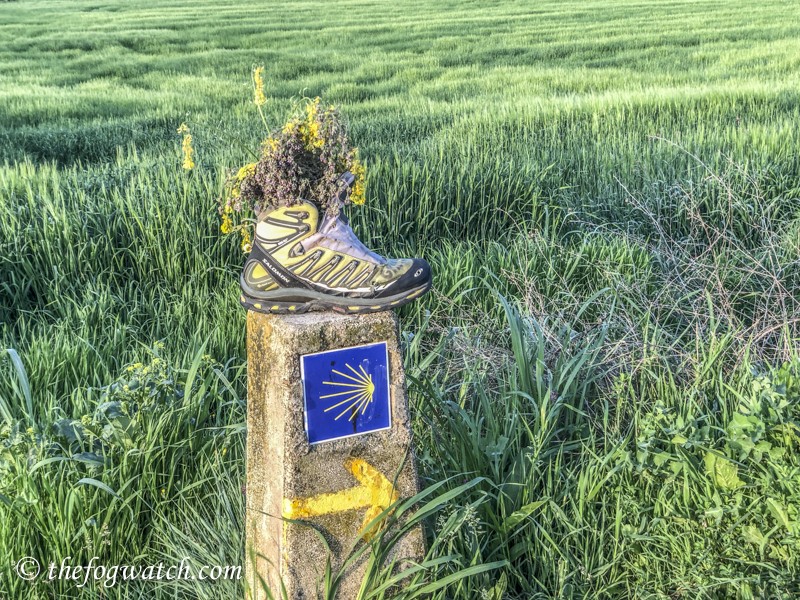 boot on Camino marker